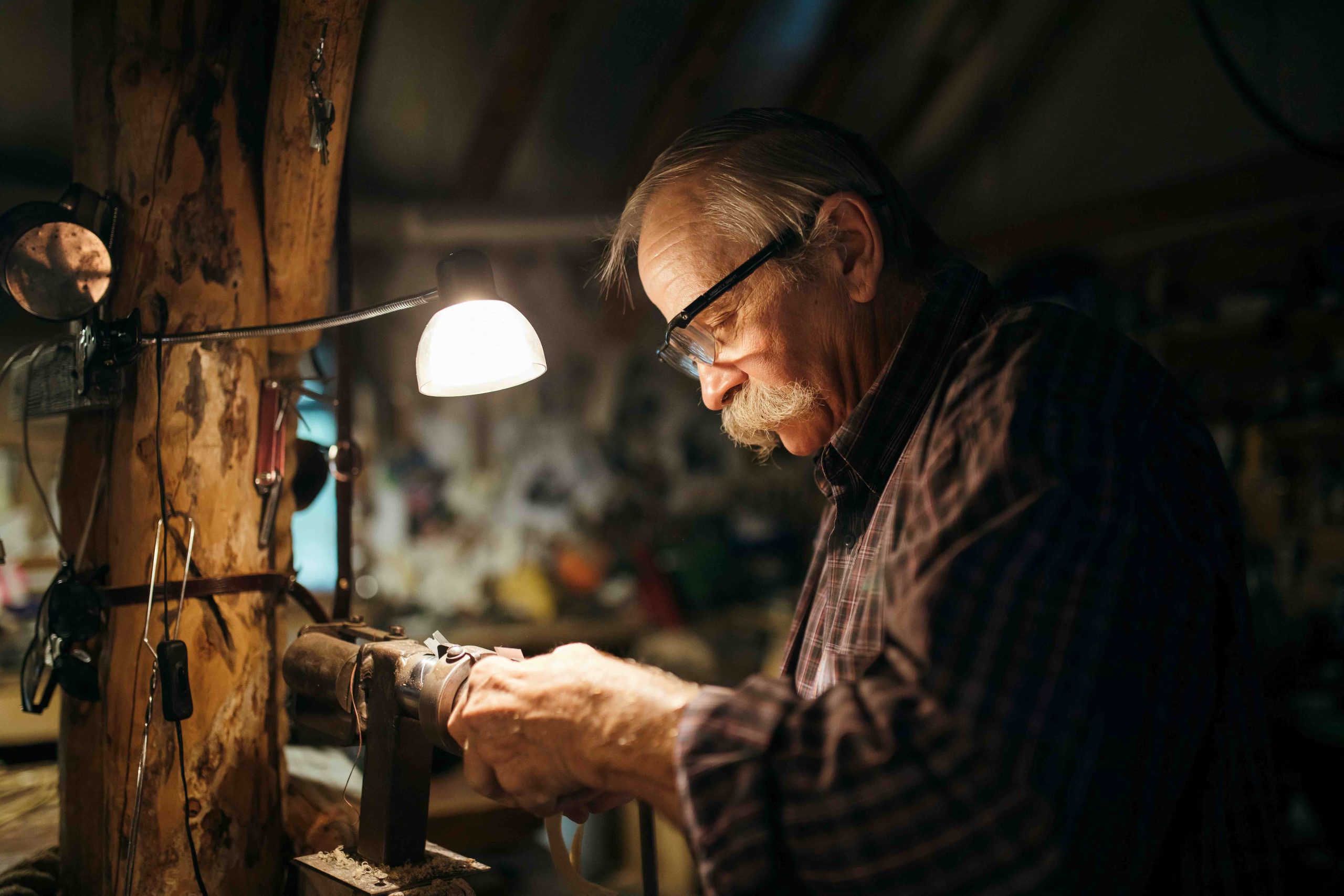Man with glasses working in workshop